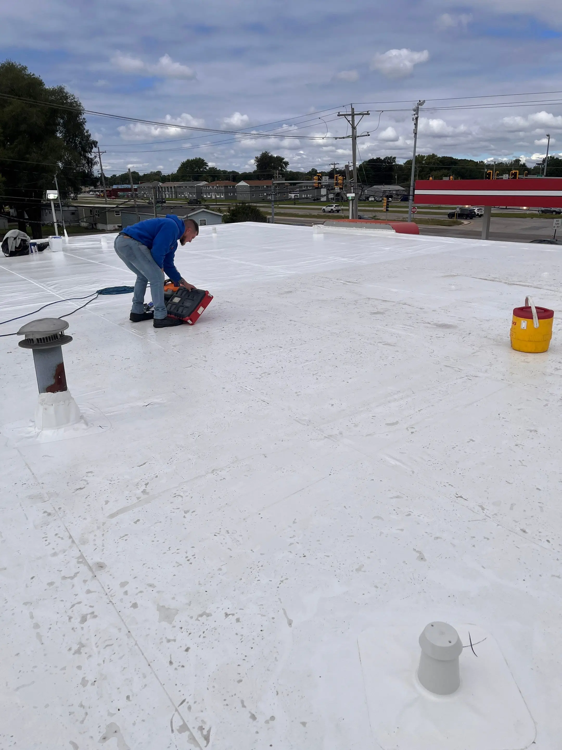 Metal retrofit roof on a convenience store in East Moline, Illinois: new Duro-Last membrane over the original metal roof
