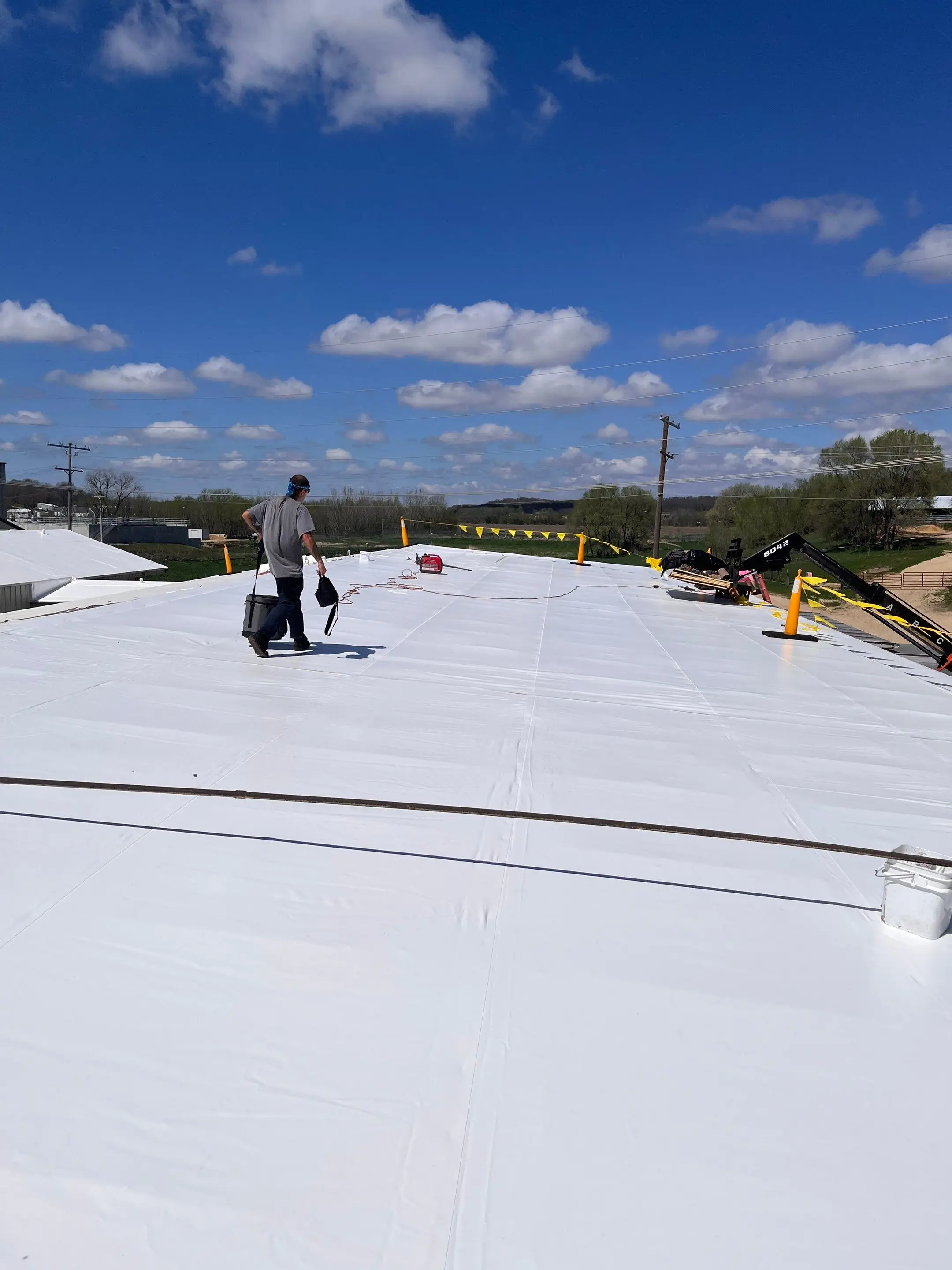 Long white Duro-Last roof on an agricultural manufacturing plant in Maquoketa, Iowa